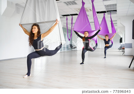 Aerial or antigravity yoga, training on hammocks Aerial or antigravity yoga, training on hammocks 77896843