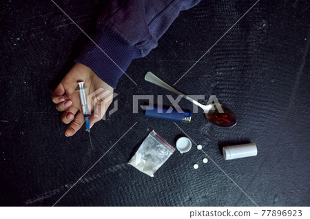 Drug addict man lying on the floor, overdose 77896923