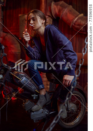 Drug addict woman smokes a cigarette 77896958