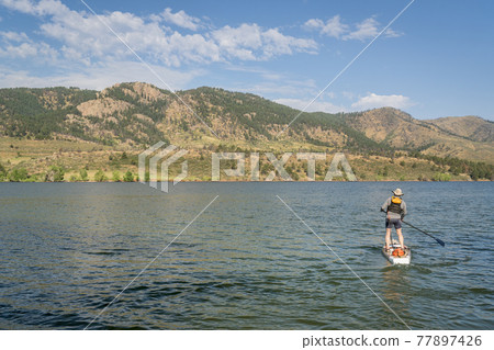 summer stand up paddleboard on lake in Colorado 77897426