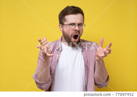 Disgruntled, aggressive Caucasian man in glasses accuses someone, he swears and indignantly Disgruntled, aggressive Caucasian man in glasses accuses someone, he swears and indignantly 77897452