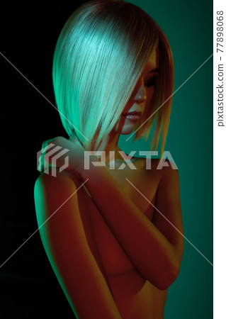 Nude sexy blonde in colorful light. Night club dance Nude sexy blonde in colorful light. Night club dance 77898068