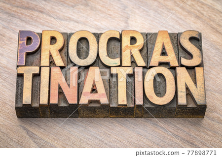 procrastination word abstract in wood type 77898771