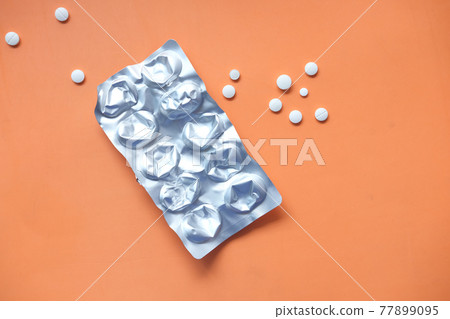 pills of blister pack and pills on orange background , flat lay pills of blister pack and pills on orange background , flat lay 77899095