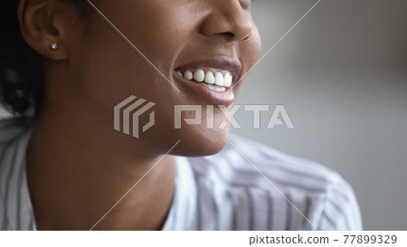Close up happy african woman showing healthy white smile. 77899329