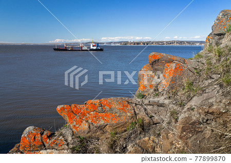 Landscape with a cargo ship in the water area of the Anadyr estuary. Landscape with a cargo ship in the water area of the Anadyr estuary. 77899870