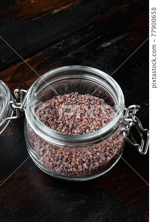 Indian Black salt, Kala namak hindi Healthy food concept, in glass jar, on old dark wooden table background 77900658
