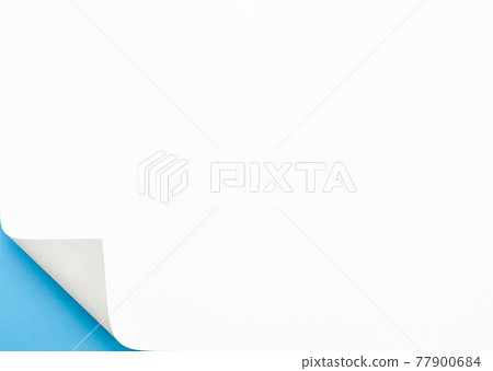 The left edge of the paper is turned over and you can see the blue background 77900684