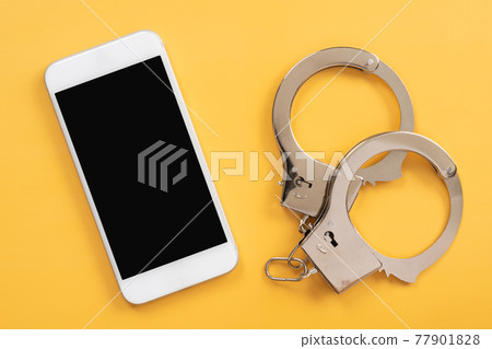 Cybercrime, crime on smartphones | Smartphones and handcuffs Cybercrime, crime on smartphones | Smartphones and handcuffs 77901828