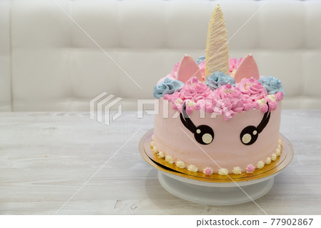 birthday cake in the form of a pink unicorn cat. Sweet cute cake 77902867