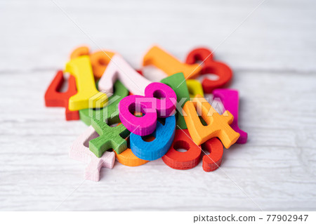 Math number colorful on wooden background, Education study mathematics learning teach concept. Math number colorful on wooden background, Education study mathematics learning teach concept. 77902947