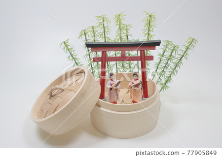 A Geisha on a flowering tree branches background A Geisha on a flowering tree branches background 77905849