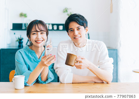 Young couple couple relaxing in the living room Young couple couple relaxing in the living room 77907863