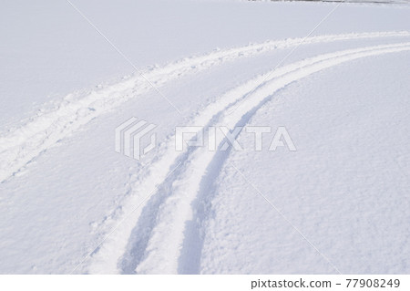 Ruts on the snowy road 77908249