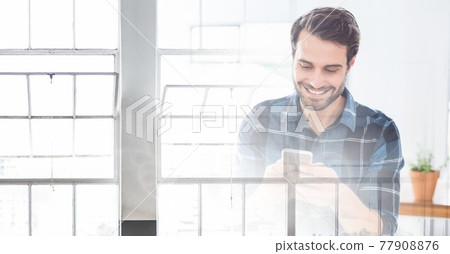 Composition of smiling man using smartphone in office with white overlay Composition of smiling man using smartphone in office with white overlay 77908876