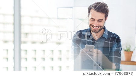 Composition of smiling man using smartphone in office with white overlay 77908877