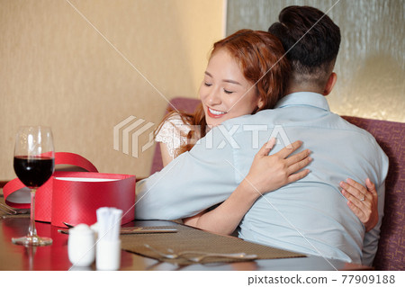 Woman embracing her boyfriend Woman embracing her boyfriend 77909188