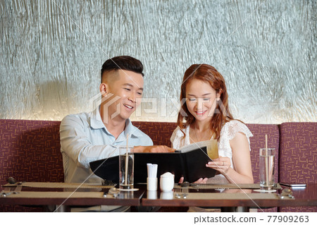 Couple reading menu 77909263