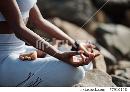 Woman practicing meditation 77910128