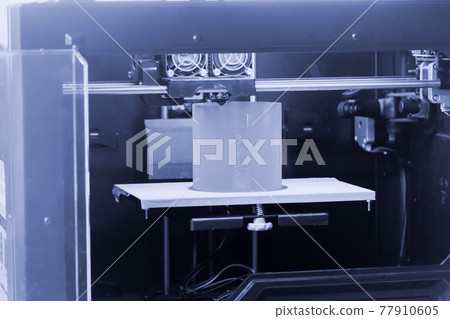 3D printer prints the form of molten plastic blue gray close-up. 77910605