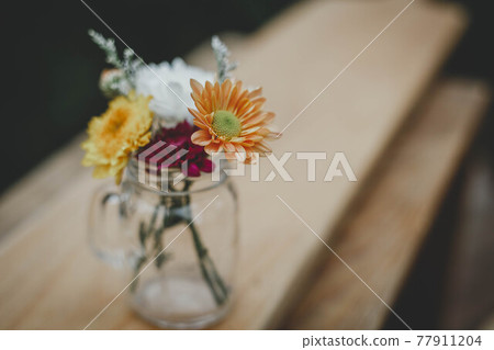 Vase with beautiful gerbera flowers on table 77911204
