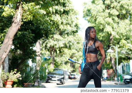 Fit woman in city park 77911379