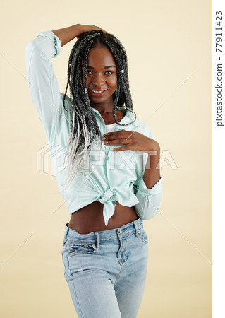 Smiling young woman with braided hairstyle Smiling young woman with braided hairstyle 77911423