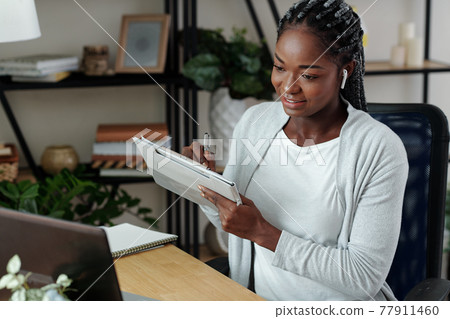 Woman watching webinar online Woman watching webinar online 77911460