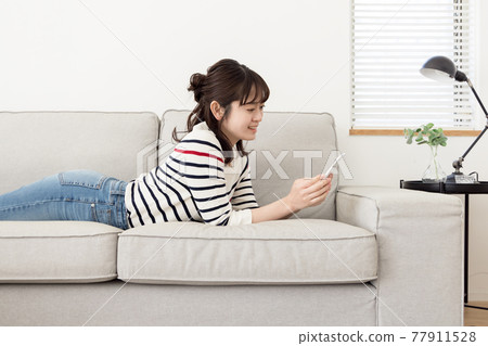 A woman relaxing on the sofa 77911528