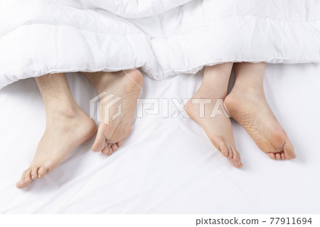 foot of person sleeping in bed foot of person sleeping in bed 77911694