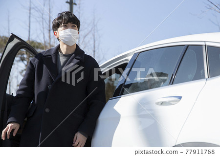 Asian Korean man with mask stepping down from car Asian Korean man with mask stepping down from car 77911768