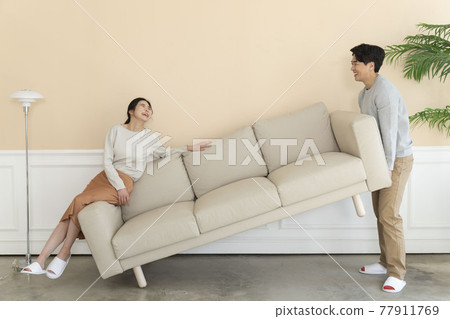 Asian newlyweds, couple moving sofa Asian newlyweds, couple moving sofa 77911769