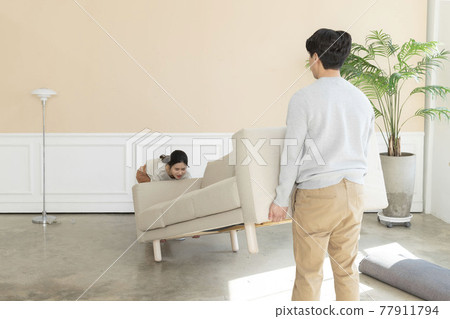 Asian newlyweds, couple moving sofa 77911794