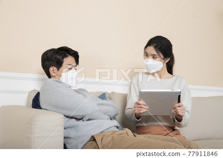 Asian couple wearing mask, worried due to covid virus Asian couple wearing mask, worried due to covid virus 77911846