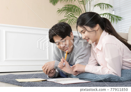 Asian newlyweds, couple managing home living expense Asian newlyweds, couple managing home living expense 77911850
