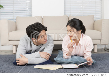 Asian newlyweds, couple managing home living expense Asian newlyweds, couple managing home living expense 77911853