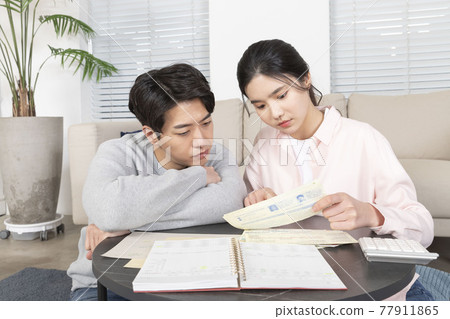 Asian newlyweds, couple managing home living expense Asian newlyweds, couple managing home living expense 77911865