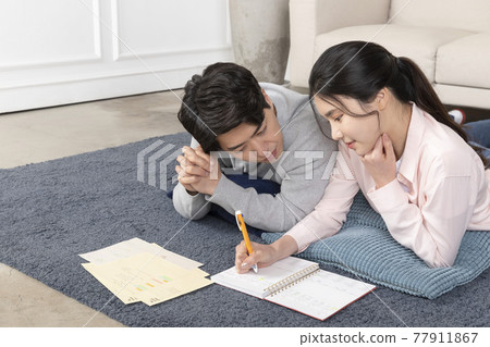 Asian newlyweds, couple managing home living expense Asian newlyweds, couple managing home living expense 77911867