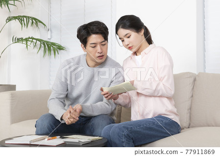 Asian newlyweds, couple managing home living expense Asian newlyweds, couple managing home living expense 77911869