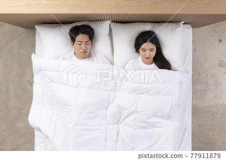 Asian newlyweds, couple sleeping in bed Asian newlyweds, couple sleeping in bed 77911879