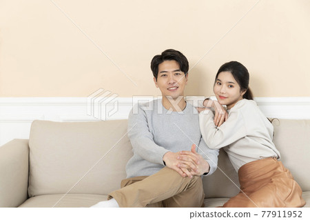 newly married Asian couple at home concept, sitting on sofa 77911952