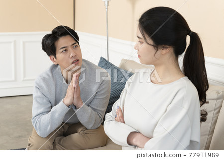 Asian couple after fight, wife apologizing to husband 77911989