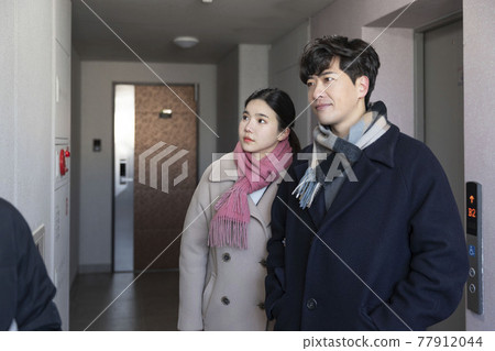newly married Asian couple standing at corridor, apartment newly married Asian couple standing at corridor, apartment 77912044