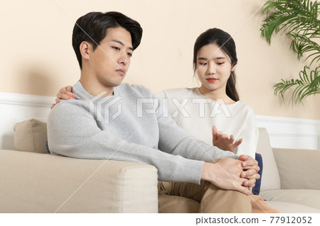 Asian wife comforting, calming down Asian husband Asian wife comforting, calming down Asian husband 77912052