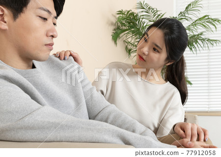 Asian wife comforting, calming down Asian husband 77912058