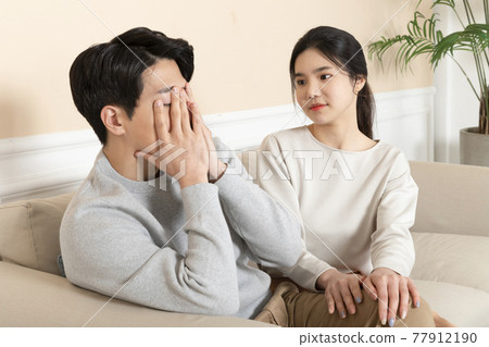 Asian wife comforting, calming down Asian husband Asian wife comforting, calming down Asian husband 77912190