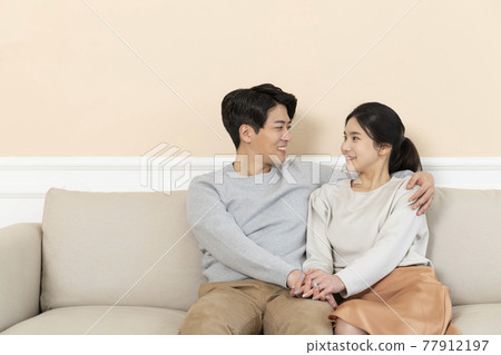 newly married Asian couple at home concept, sitting on sofa 77912197