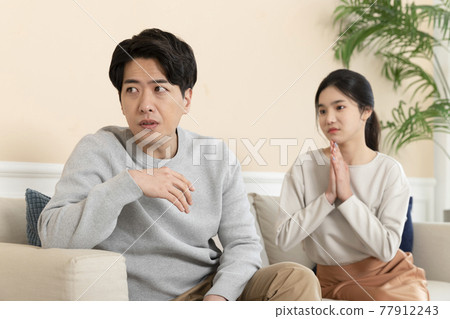 Asian couple after fight, wife apologizing to husband 77912243