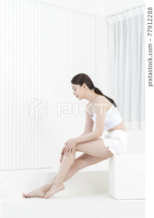 Beautiful Asian model in white slip and shorts, body and skin beauty concept Beautiful Asian model in white slip and shorts, body and skin beauty concept 77912288