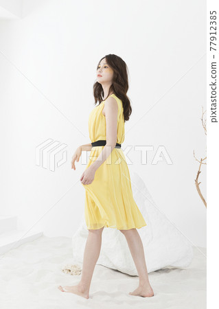 beautiful Asian model in yellow dress, spring beauty concept 77912385